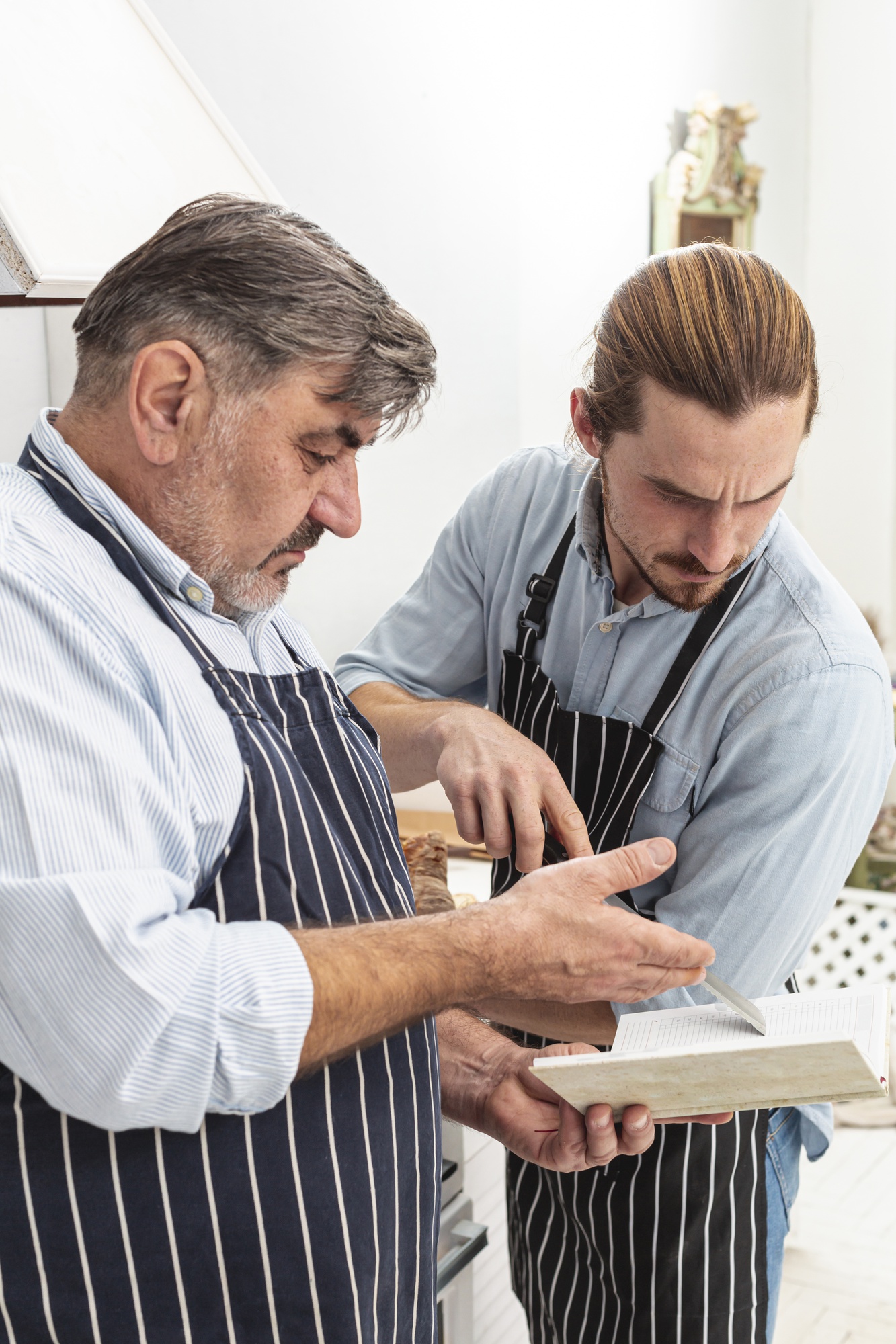Chef advising client over a menu